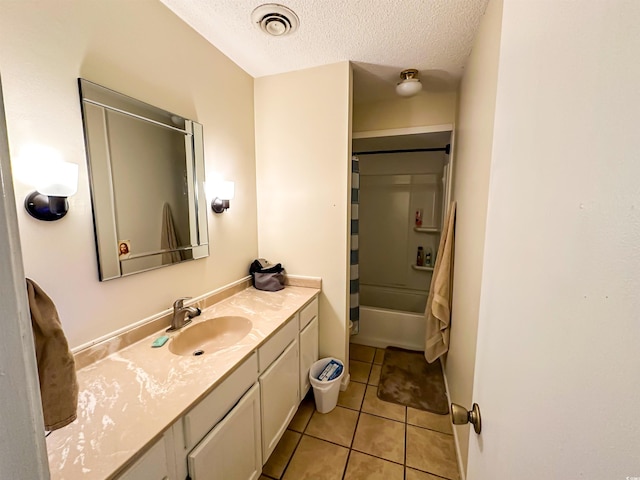 full bath with vanity, a textured ceiling, visible vents, tile patterned flooring, and shower / bath combination