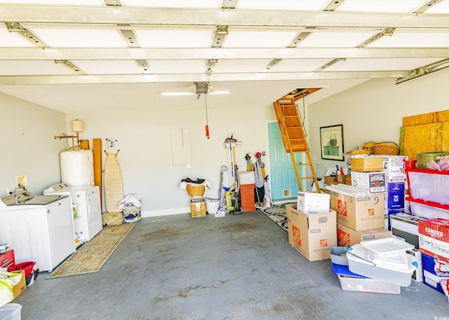 garage featuring water heater, a garage door opener, and washing machine and clothes dryer