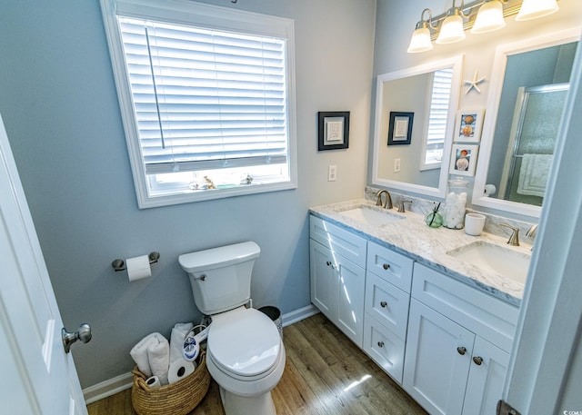 bathroom with a healthy amount of sunlight, a sink, and toilet