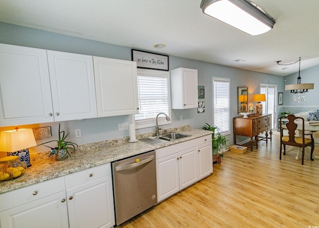 kitchen featuring a sink, white cabinets, stainless steel dishwasher, light wood-type flooring, and decorative light fixtures