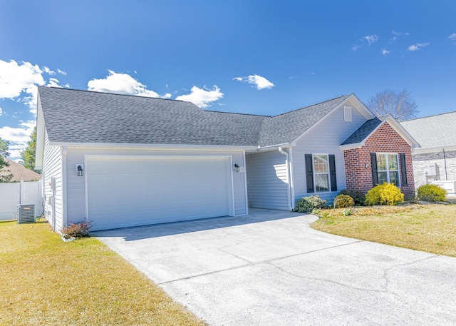 ranch-style house with central air condition unit, an attached garage, concrete driveway, and a front yard