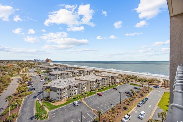 birds eye view of property featuring a water view and a beach view