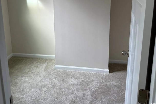 carpeted empty room with baseboards