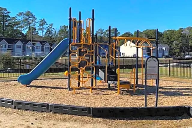 community play area with a residential view and fence