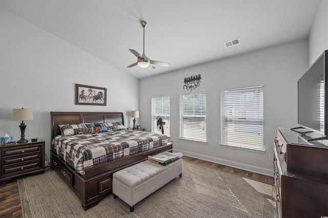 bedroom with visible vents, baseboards, dark wood finished floors, and vaulted ceiling