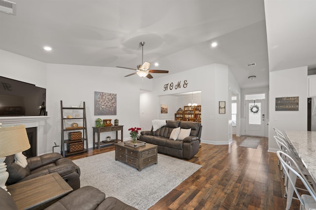 living area featuring a fireplace, dark wood-style floors, visible vents, and ceiling fan