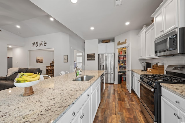 1201 Ficus Dr, Myrtle Beach, SC 29579 - kitchen featuring stainless steel appliances, open floor plan, white cabinetry, dark wood-type flooring, and light stone countertops