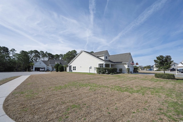 view of side of home with a yard and a garage