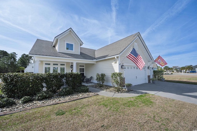 view of front of property with driveway, a front lawn, and a garage