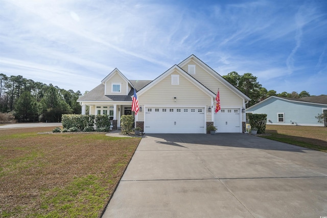 view of front of house featuring a front yard, concrete driveway, and a garage