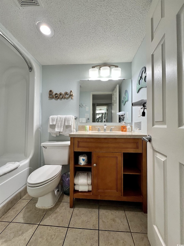 bathroom with tile patterned floors, toilet, and a textured ceiling