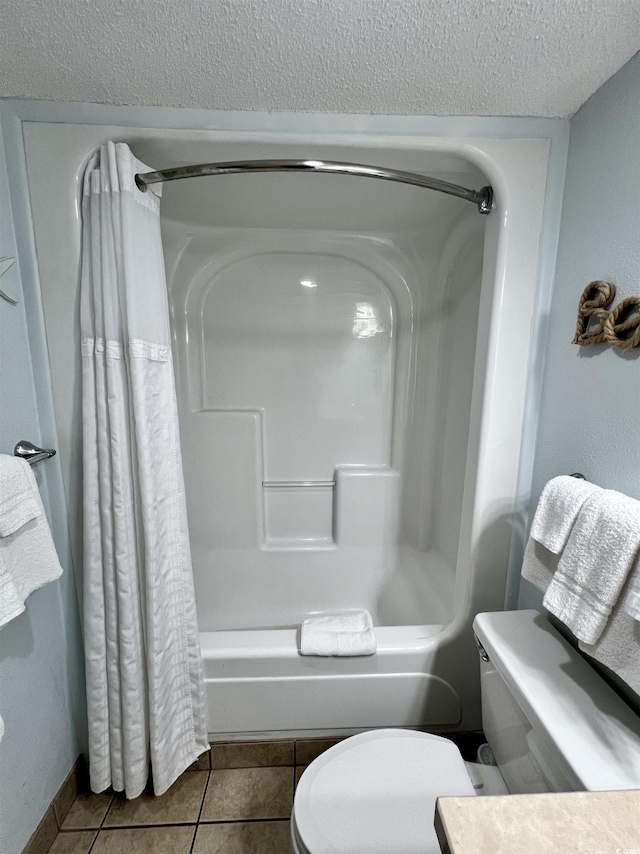 bathroom featuring tile patterned floors, toilet, a textured ceiling, and shower / bathtub combination with curtain