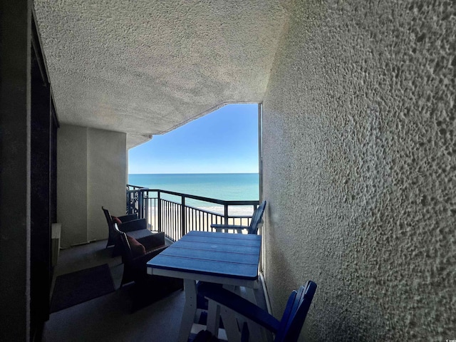 balcony featuring a water view