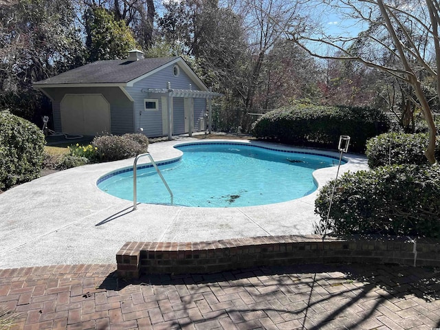 view of pool featuring a fenced in pool, an exterior structure, a patio area, fence, and an outdoor structure