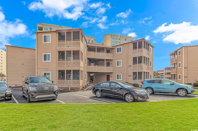 view of building exterior with uncovered parking