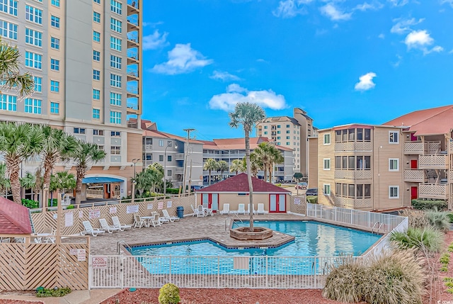 pool featuring a patio area and fence