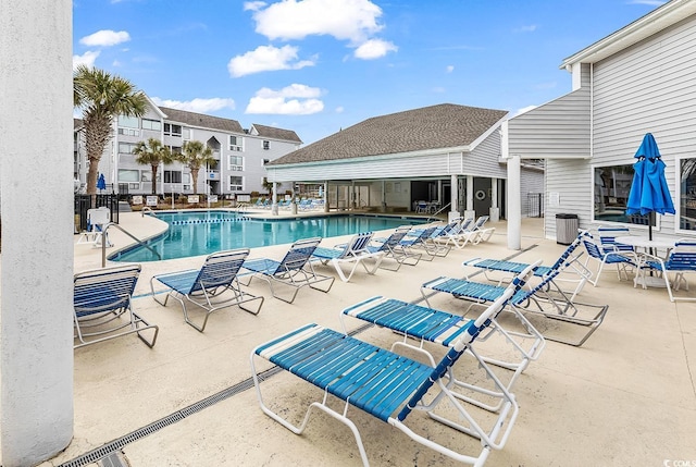 pool featuring a patio area and fence