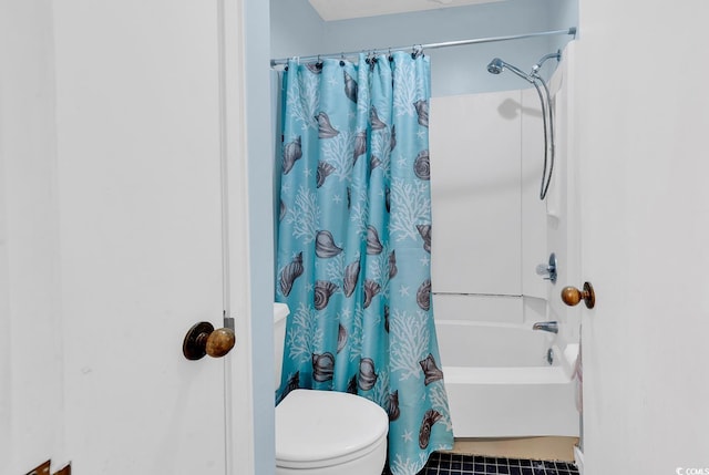 bathroom featuring shower / bath combination with curtain and toilet