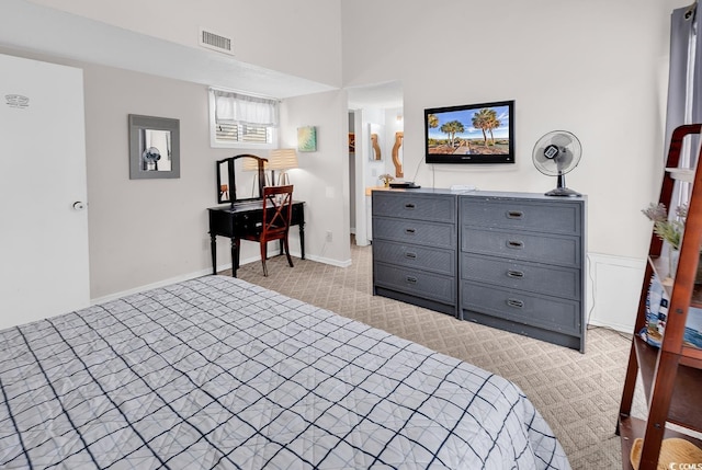 bedroom featuring visible vents and light colored carpet