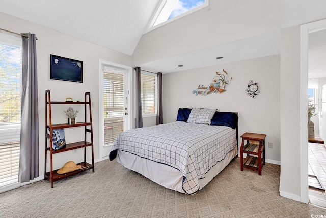 bedroom with light colored carpet, vaulted ceiling, and baseboards