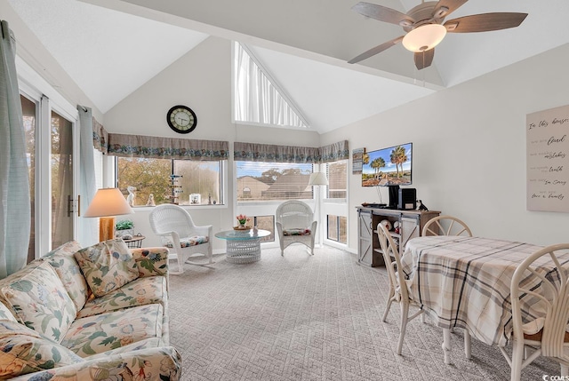 carpeted living room featuring high vaulted ceiling and a ceiling fan