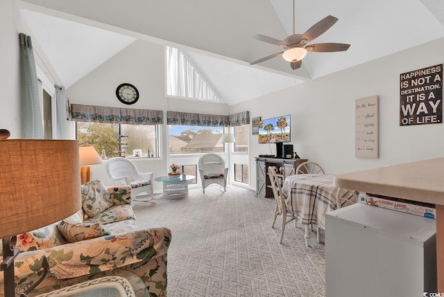 carpeted living area with a sunroom, ceiling fan, and high vaulted ceiling