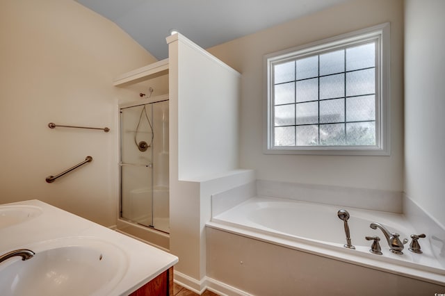 full bath featuring a stall shower, double vanity, a sink, and a bath