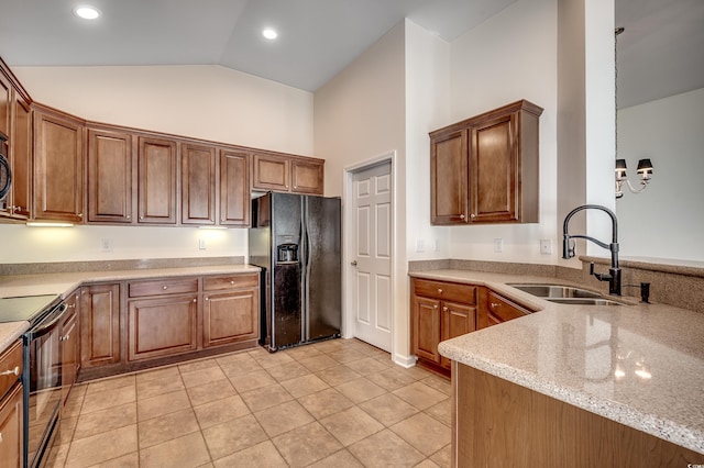 kitchen featuring light tile patterned floors, recessed lighting, a sink, light stone countertops, and black appliances