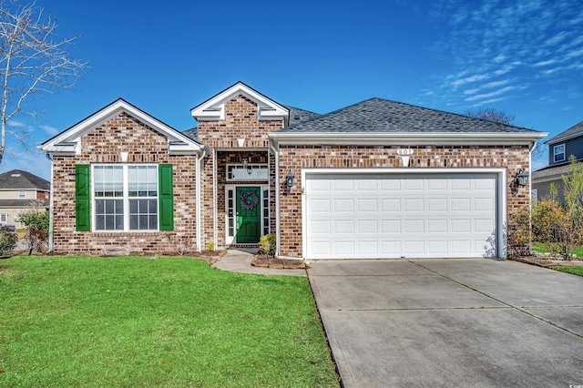 view of front of home featuring a garage, brick siding, driveway, roof with shingles, and a front yard