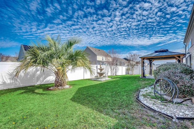 view of yard with a gazebo and a fenced backyard