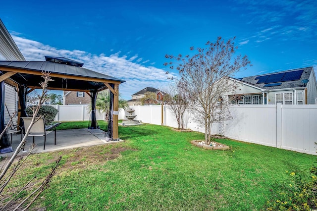 view of yard featuring a gazebo, a patio area, and a fenced backyard