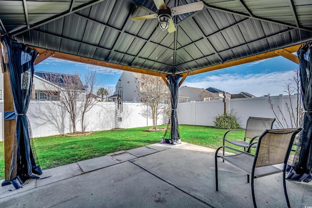 view of patio with ceiling fan, a gazebo, and a fenced backyard