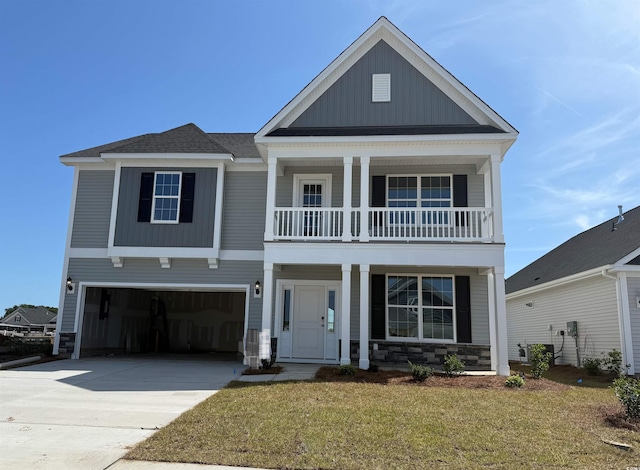 4035 Bucolic Loop, Myrtle Beach, SC 29588 - view of front of house with covered porch, a garage, stone siding, driveway, and a front yard