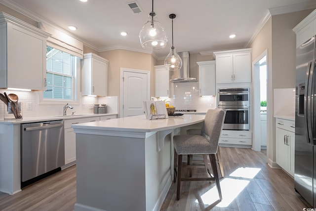 4035 Bucolic Loop, Myrtle Beach, SC 29588 - kitchen featuring stainless steel appliances, wall chimney exhaust hood, a center island, backsplash, and crown molding
