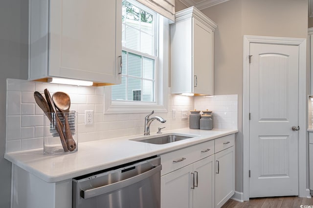 4035 Bucolic Loop, Myrtle Beach, SC 29588 - kitchen with stainless steel dishwasher, a sink, white cabinets, light countertops, and backsplash