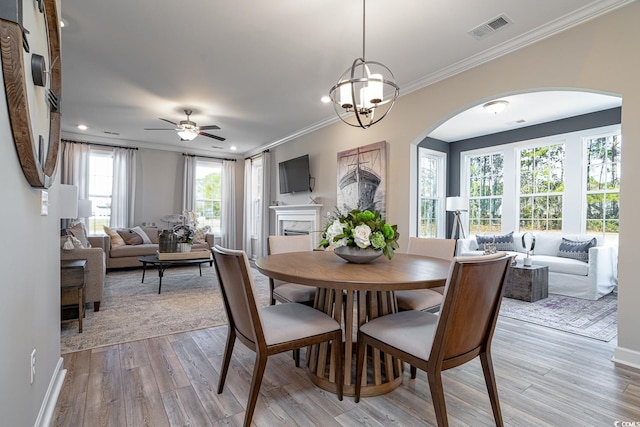 4035 Bucolic Loop, Myrtle Beach, SC 29588 - dining area featuring ornamental molding, light wood finished floors, ceiling fan, arched walkways, and recessed lighting