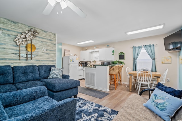 6001-1222 S Kings Hwy, Myrtle Beach, SC 29575 - living area featuring an accent wall, light wood finished floors, and ceiling fan