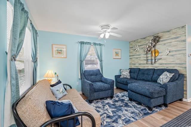 6001-1222 S Kings Hwy, Myrtle Beach, SC 29575 - living area featuring baseboards, an accent wall, a ceiling fan, and wood finished floors