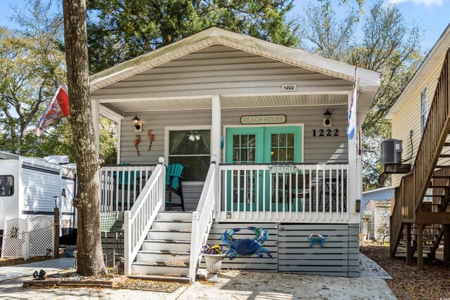 6001-1222 S Kings Hwy, Myrtle Beach, SC 29575 - view of front of home featuring stairway, covered porch, and central AC