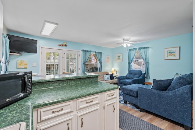 6001-1222 S Kings Hwy, Myrtle Beach, SC 29575 - kitchen with dark countertops, a healthy amount of sunlight, and black microwave