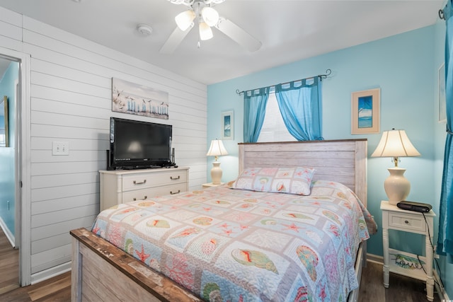 6001-1222 S Kings Hwy, Myrtle Beach, SC 29575 - bedroom featuring dark wood finished floors, a ceiling fan, and wood walls