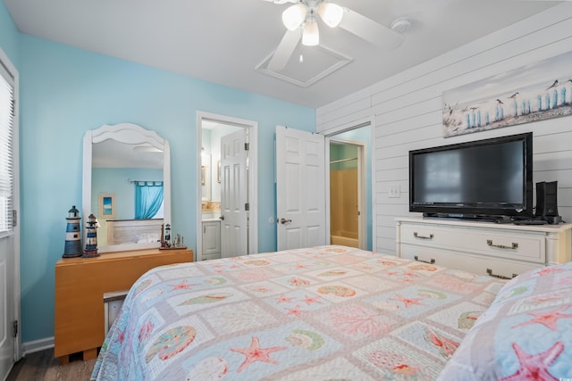 6001-1222 S Kings Hwy, Myrtle Beach, SC 29575 - bedroom featuring attic access, wood walls, a ceiling fan, and connected bathroom