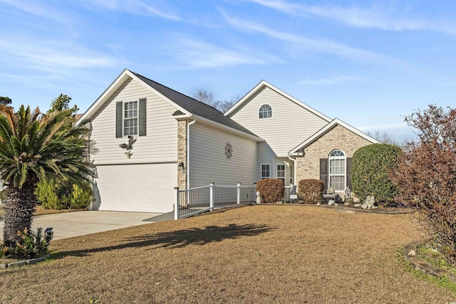 traditional-style house with a garage, brick siding, driveway, and a front lawn