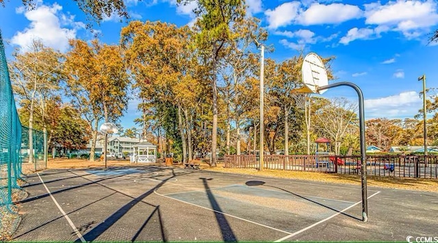 view of basketball court with community basketball court and fence