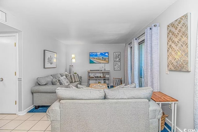 living room featuring light tile patterned floors and baseboards