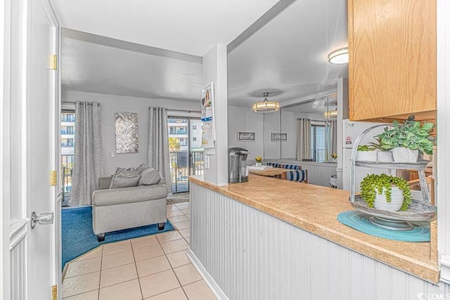 kitchen featuring light tile patterned floors, light countertops, and open floor plan