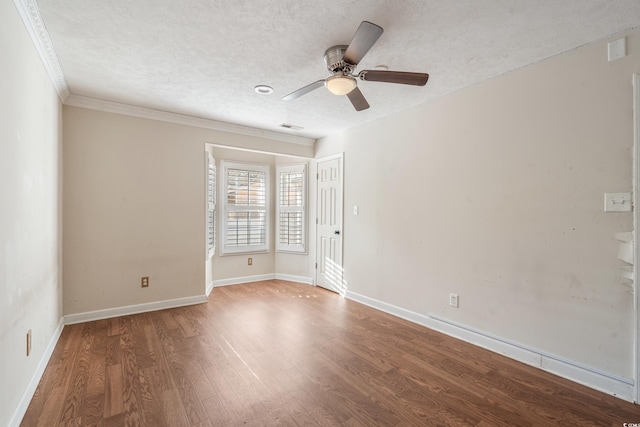 unfurnished room with visible vents, baseboards, ornamental molding, wood finished floors, and a textured ceiling