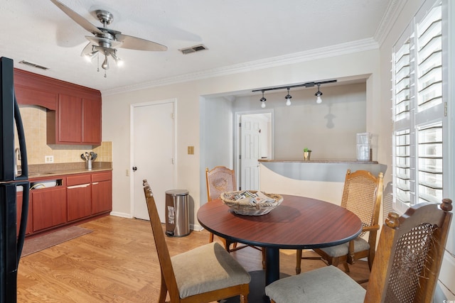 dining area with light wood-type flooring, ceiling fan, visible vents, and crown molding