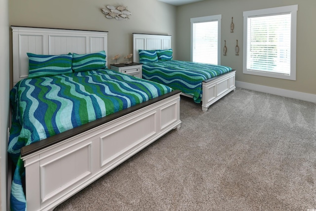 carpeted bedroom with baseboards