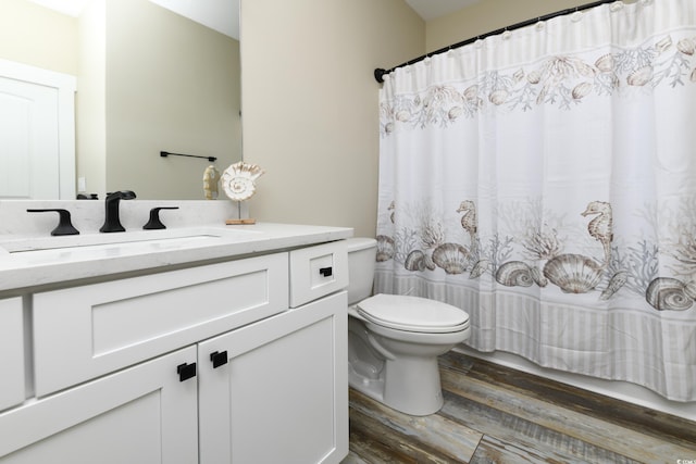 full bathroom with vanity, a shower with shower curtain, toilet, and wood finished floors